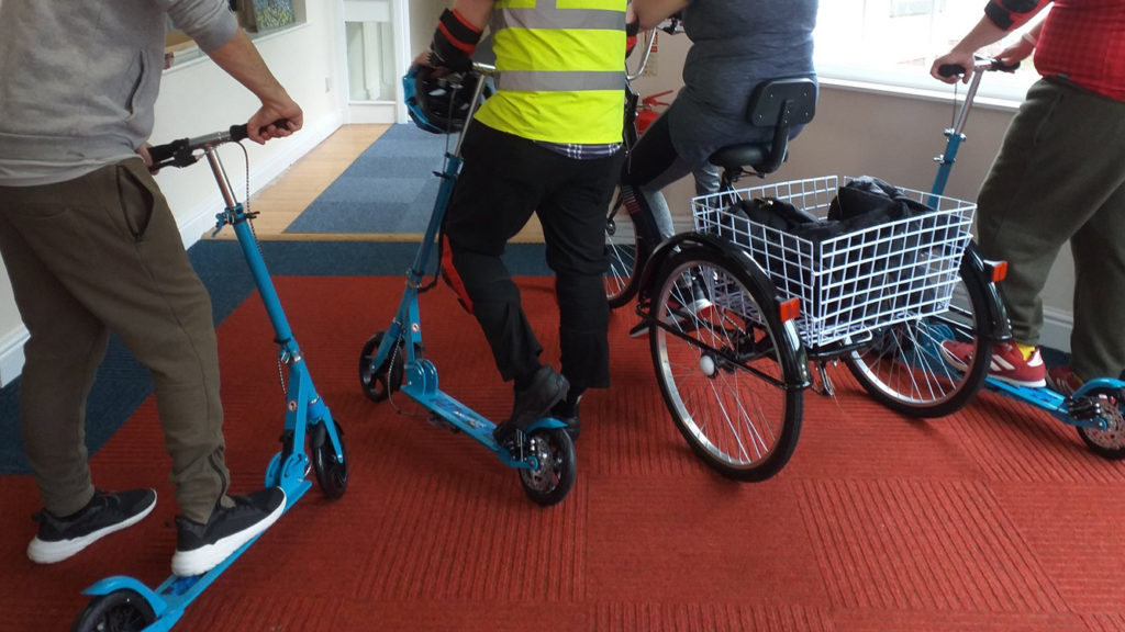 MHC residents try out the scooters and tricycle